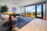 Enjoy light pouring through avant-garde windows in living room and kitchen spaces